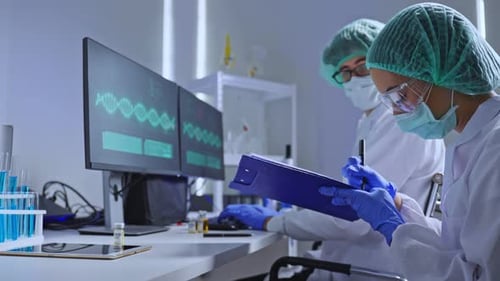 Scientists Researching DNA Data in a Modern Lab