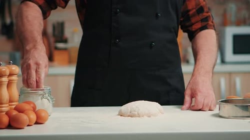 Adult Preparing Dough at Kitchen Counter