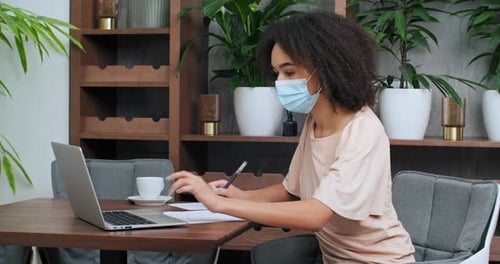 Young Adult Woman Working at Home with Laptop