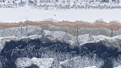 Snowy beach at Baltic sea in winter. Aerial view, Poland