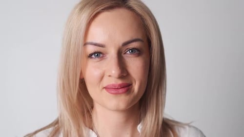 Caucasian Woman with Blond Hair in White Shirt Close Up Portrait