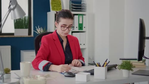Woman Working at Desk in Bright Office