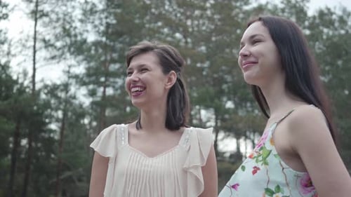 Portrait Two Cute Smilling Young Women Wear Summer Dresses Standing in the Top of Rock