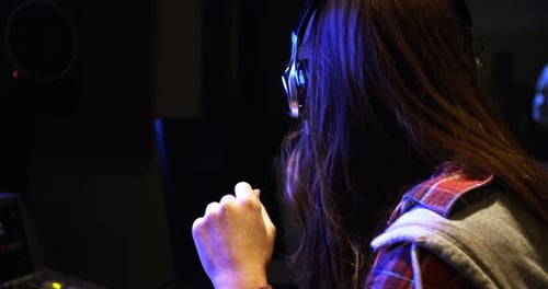 Female audio engineer using sound mixer