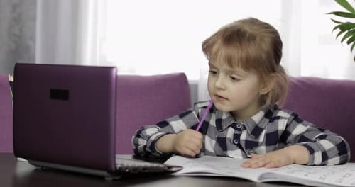 Young Child Learning From Home With a Laptop