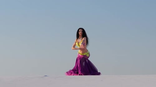 Woman Dancing Solo in Desert With Colorful Costume