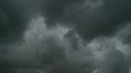 Time lapse of clouds over rural landscape with green hills