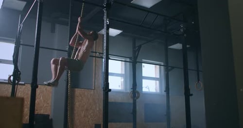 the Man Climbs Up the Rope and Reaches the Top. the Concept of Success Through Hard Work