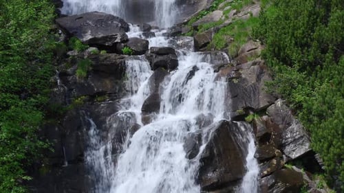 Majestic Waterfall Cascading Down Rocky Terrain