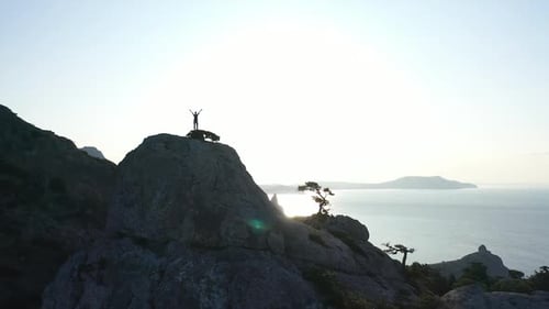 Stunning Aerial Drone Shot, Young Woman Just Reached the Mountain Top. Adventure Woman with Arms