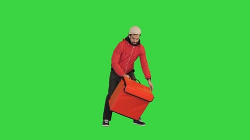 Food Delivery Courier Leaving the Food on a Backpack and Taking Out Payment Terminal Looking on