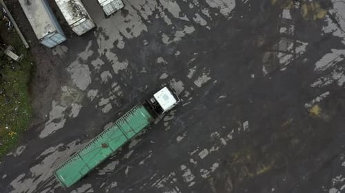 The Car Wagon Bringing a Container for Unloading in the Warehouse