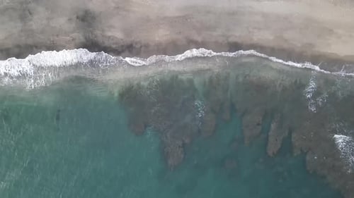 Aerial View of Waves Crashing on Beach