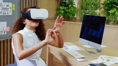 Woman Using VR Headset at Office Desk