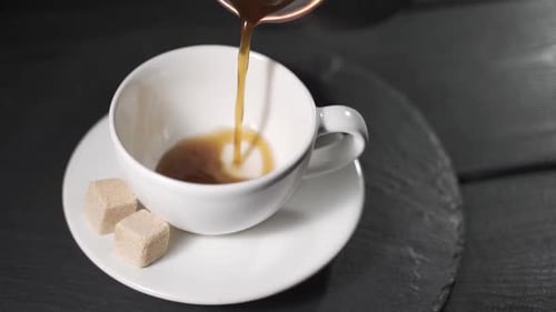 Coffee Pouring into Cup with Brown Sugar