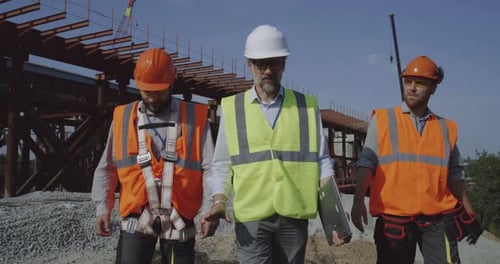 Professional Engineers Walking Towards Unfinished Bridge
