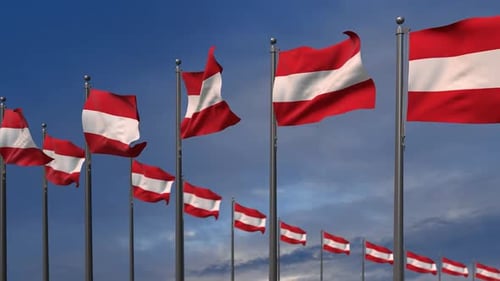 Waving Austrian Flags Against a Blue Sky Background