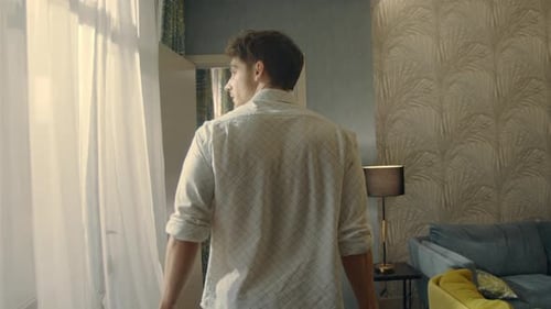 Handsome Guy Coming in Luxury Apartment. Attractive Man Falling Hotel Bed.