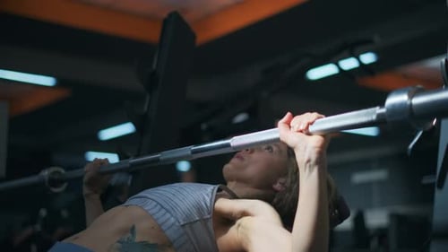 Fitness Girl Is Exercising with in a Gym. Sporty Woman Is Lifting a Weight. Fitness, Body and Health