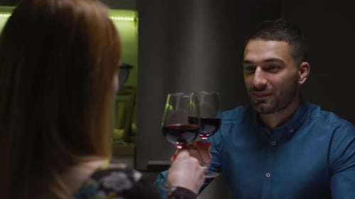 Couple toasting and drinking red wine