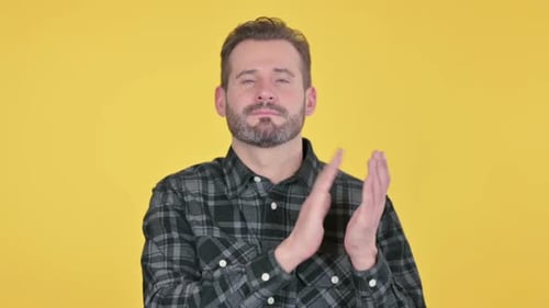 Man Clapping Hands on Yellow Background
