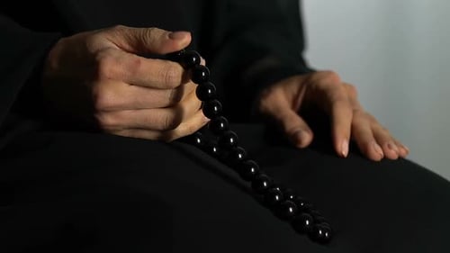 Hands with prayer beads