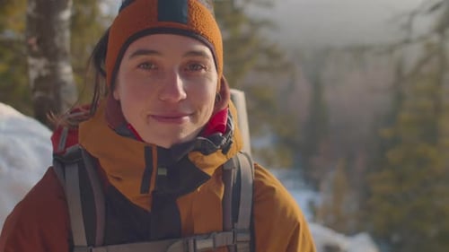 Smiling Woman Hiker in Snowy Winter Forest