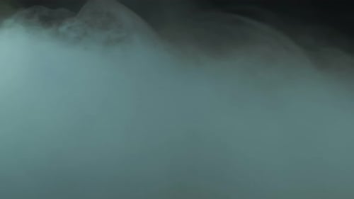 Turquoise Cloud Swirls Against Dark Background