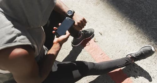 Person Using Phone Outdoors After Exercise
