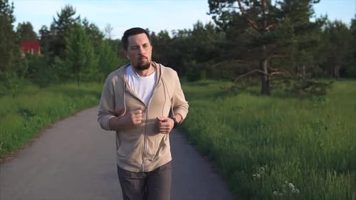 Man Who Is Engaged in Sports Running Is Preparing for a Sprint in the Park Area