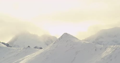 Aerial helicopter shot, zoom out from kids playing hockey on frozen pond, wave, skate around doing t