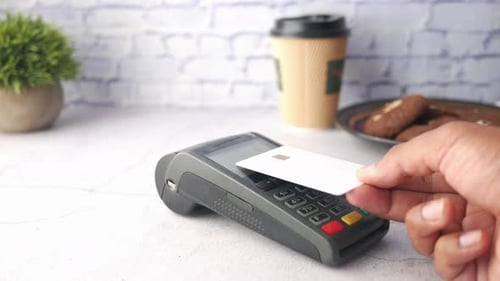 Contactless Payment Concept with Young Man Paying with Credit Card