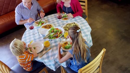 Family Enjoying Healthy Meal Together at Restaurant