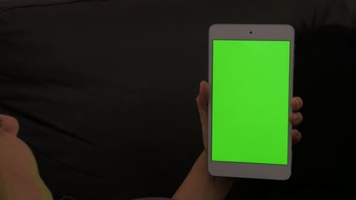 Green screen PC tablet at home chroma key tablet 4K 2160p 30fps UltraHD footage - Young female green