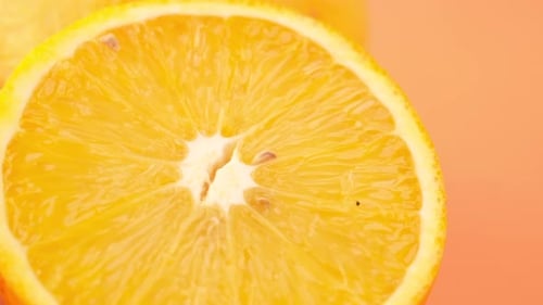 Close Up of Slice of Orange Fruit on Color Background