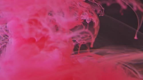 Red Paint Spreads in Water, Beautiful Streaks of Paint. Jet of Paint Dissolves in Water, Large