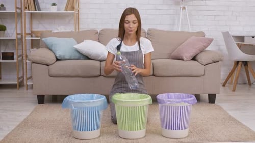Woman Recycles Plastic Bottle in Living Room