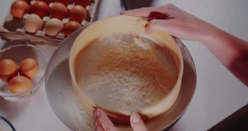Woman in the Kitchen Pours Flour Into a Bowl Closeup