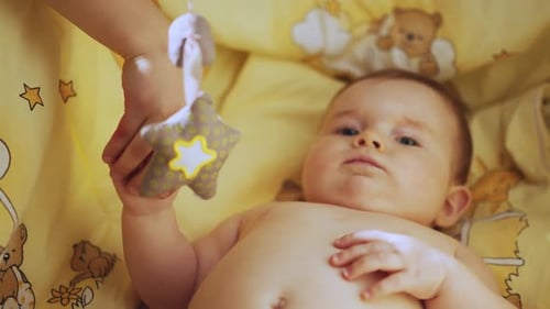 Close Up Footage of Newborn Baby Playing With Mother's Hand and Finger While