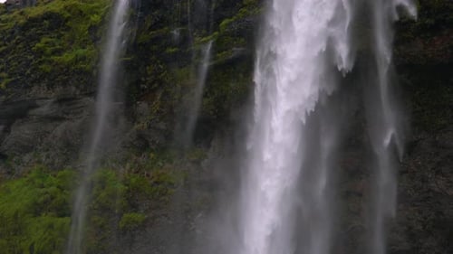 Water Flows Down a Powerful Stream at a Waterfall