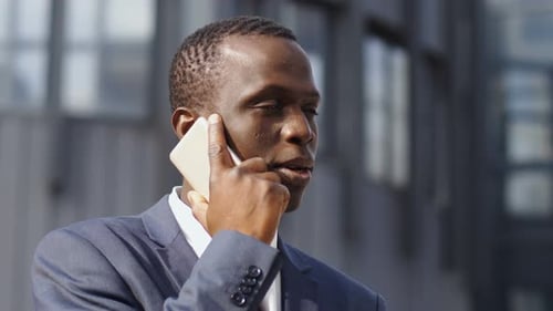 African American Businessman on The Street Talking with Smartphone