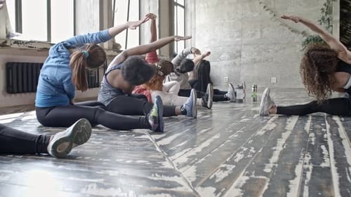 Group of Women Stretching in Flexibility Class