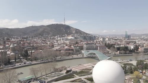 Tbilisi, Georgia - April 2 2021: Aerial view of Tbilisi city central park and Bridge of Peace.