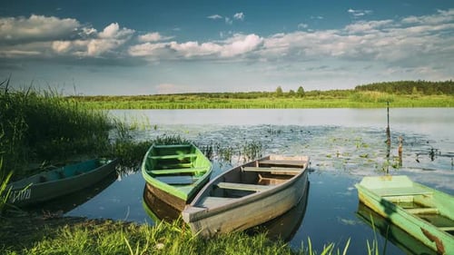 Lake Or River And Old Wooden Rowing Fishing Boats In Beautiful Summer Sunny Evening