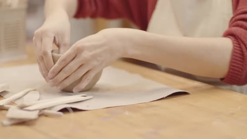 Woman Shaping Clay Bowl in Studio