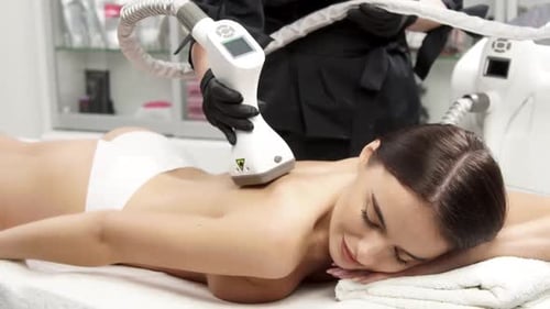 Woman Receiving Laser Skin Treatment on Back