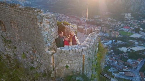 Family Exploring Castle Ruins at Sunset