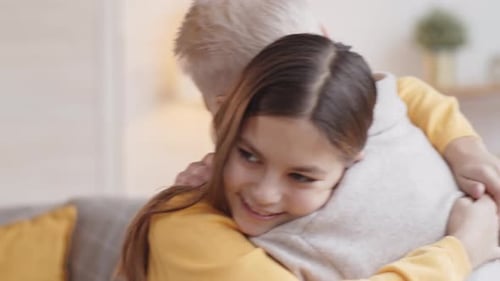 Child Gives Affectionate Hug to Grandparent at Home