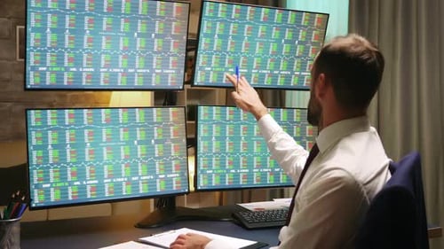 Businessman in Suits Looking at Graphs