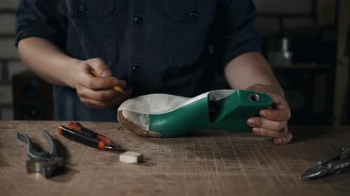 Shoemaker Working on Shoe Form in Workshop